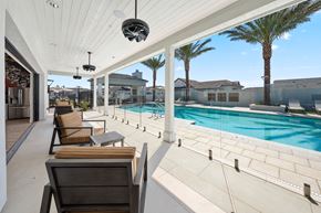Surprise apartment for rent - A patio with a pool and chairs.
