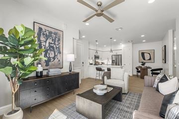Avondale apartment for rent - A living room with a ceiling fan and a large painting on the wall.