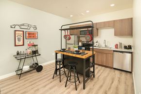 Peoria apartment for rent - A kitchen with a table and chairs in the middle of the room.