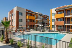 Peoria apartment for rent - A large apartment complex with a pool in the courtyard.