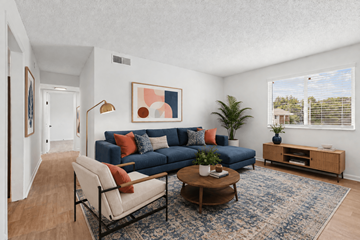 Hendersonville apartment for rent - A living room with a blue couch and a painting on the wall.