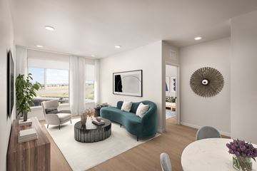 Lone Tree apartment for rent - A modern living room with a green sofa and a large window.