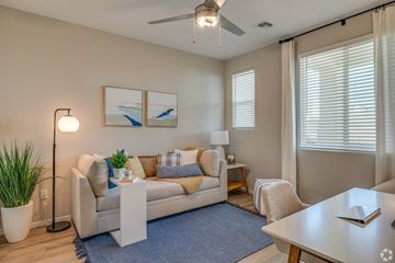 Surprise apartment for rent - A living room with a couch, a floor lamp, and a painting on the wall.