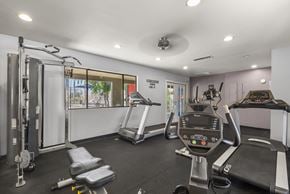 Glendale apartment for rent - A gym with a treadmill, a stationary bike, and a weight machine.