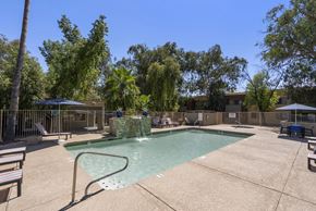 Glendale apartment for rent - A pool with a slide and a fence around it.
