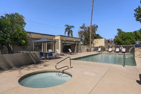 Glendale apartment for rent - A pool with a ladder and chairs in front of a house.