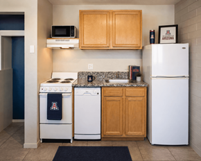 Tucson apartment for rent - A kitchen with a white refrigerator, a white stove, a white dishwasher, and a white microwave.
