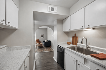 San Antonio apartment for rent - A kitchen with white cabinets and a marble countertop.