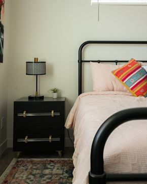 Mesa apartment for rent - A bedroom with a bed, a nightstand with a lamp, and a rug.