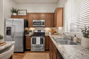 Tucson apartment for rent - A kitchen with a refrigerator, oven, and sink.