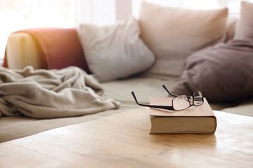 Hendersonville apartment for rent - a book with glasses sitting on a table in a living room