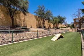 Goodyear apartment for rent - A playground with a yellow slide and green grass.