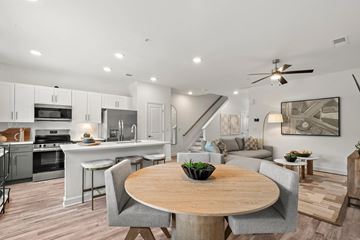 South Fulton townhouse for rent - A modern open-concept kitchen and living room with a dining table and chairs.