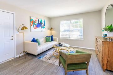 Murfreesboro apartment for rent - A living room with a white couch, a yellow chair, and a painting on the wall.