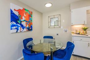 Murfreesboro apartment for rent - A dining room with a glass table and blue chairs.