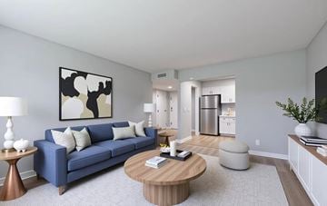 Lexington apartment for rent - A living room with a blue couch and a coffee table.
