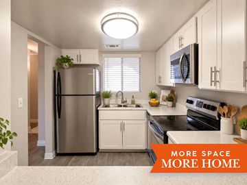 Tucson townhouse for rent - A kitchen with a refrigerator, sink, and oven.