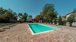 Lexington apartment for rent - A rectangular pool surrounded by a brick patio.