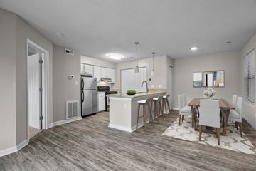 Carrboro apartment for rent - A modern kitchen with a dining table set for four.