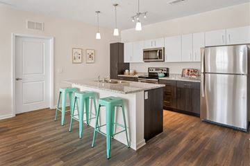 Fort Myers apartment for rent - A kitchen with a white counter top and a refrigerator.