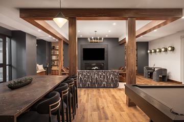 Northglenn apartment for rent - A modern living room with a pool table and a bar area.