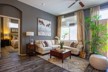 Tucson apartment for rent - A living room with a white couch and a painting on the wall.