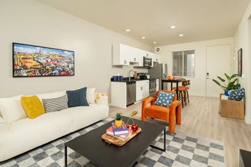 Glendale apartment for rent - A living room with a white couch and a painting on the wall.