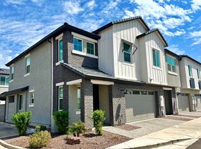 Phoenix townhouse for rent - A modern two-story house with a garage and a driveway.