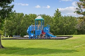 Hendersonville apartment for rent - A playground with a blue slide and a green roof.