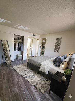 Tempe apartment for rent - A bedroom with a bed, a dresser, and a mirror.