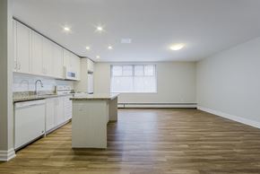 Toronto apartment for rent - an empty kitchen and living room with white cabinets and a counter top at 107 Redpath, Toronto, CA M4S 2J9