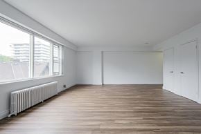 Toronto apartment for rent - a living room with a large window and wooden floors at 161 St. George, Canada