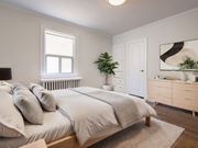 Scarborough apartment for rent - A bedroom with a large bed, a window, a dresser, and a mirror at Queen St East in Scarborough, ON