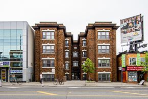 Toronto apartment for rent - A brick building with a bicycle parked in front of it at 723 Bloor Apartments, Toronto, CA, M6G 1L5