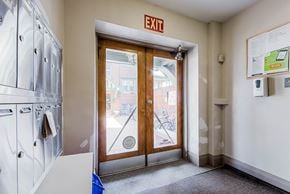 Toronto apartment for rent - a laundry room with a door and a exit sign at 83-85 Silver Birch, Toronto Canada