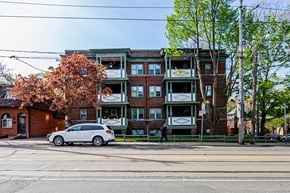 Toronto apartment for rent - a car parked on a street in front of an apartment building at 83-85 Silver Birch, Toronto, CA M4E 3L2