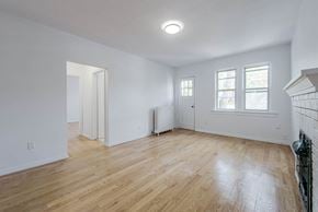 Toronto apartment for rent - a living room with white walls and wood floors and a fireplace at 83-85 Silver Birch, Toronto, M4E 3L2