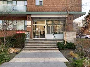 Toronto apartment for rent - the front of a brick building with stairs and a glass door at 161 St. George, Toronto, CA
