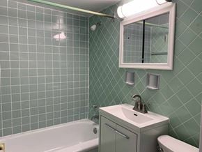 Toronto apartment for rent - a bathroom with green tiles and a sink and a bath tub at 177 Saint George in Toronto, CA