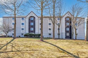 Meriden apartment for rent - a white apartment building with trees in front of it at The Meriden, Connecticut, 06450