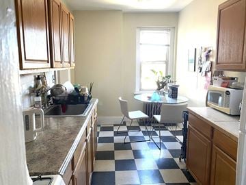 New Haven apartment for rent - A kitchen with a checkered floor and a table with chairs.