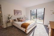 Farmington apartment for rent - a bedroom with a bed and a sliding glass door at Up House, Farmington