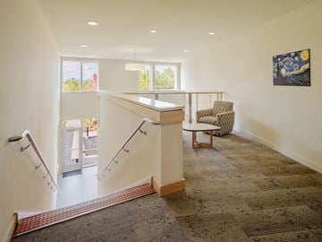 South Burlington apartment for rent - a living room with a staircase and a chair