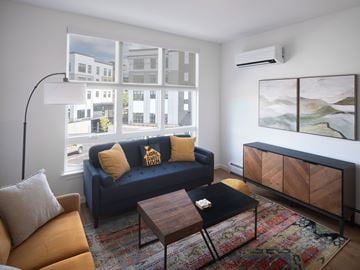 South Burlington apartment for rent - A living room with a blue couch and a wooden coffee table.