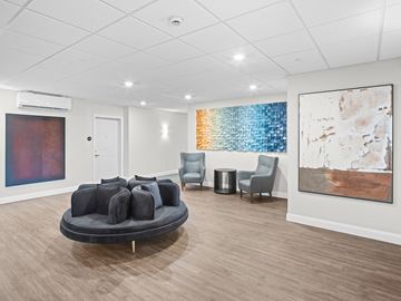 South Burlington apartment for rent - A living room with a grey couch and a painting on the wall.