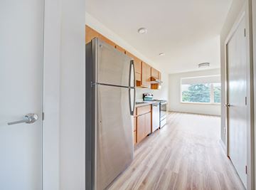 Burlington apartment for rent - a kitchen with a stainless steel refrigerator and wooden cabinets
