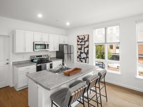 South Burlington apartment for rent - A kitchen with white cabinets and a grey countertop.