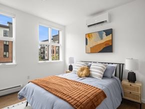 South Burlington apartment for rent - A bedroom with a large bed and a painting on the wall.
