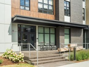 South Burlington apartment for rent - A modern building with a glass door and a number 223 on it.