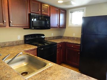 Shelburne apartment for rent - a kitchen with black appliances and granite counter tops